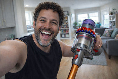 Rob holding a Dyson vacuum